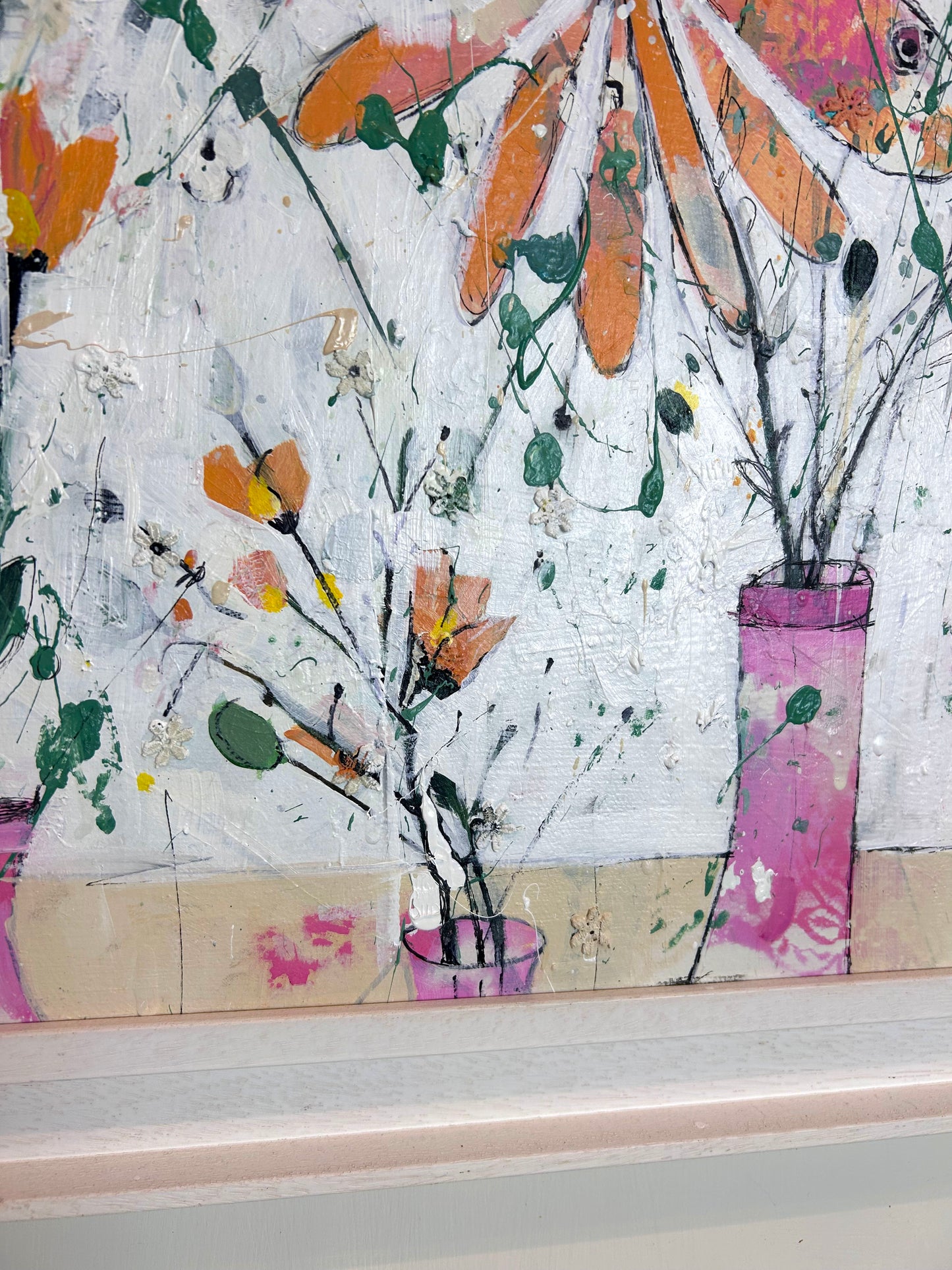 Orange flowers in pink vases