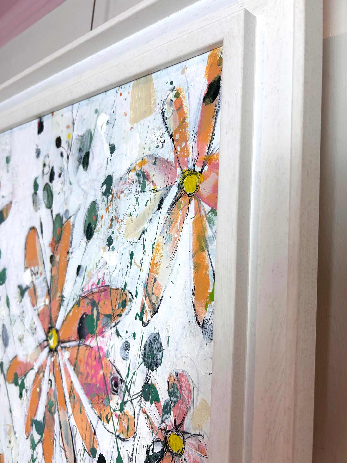 Orange flowers in pink vases