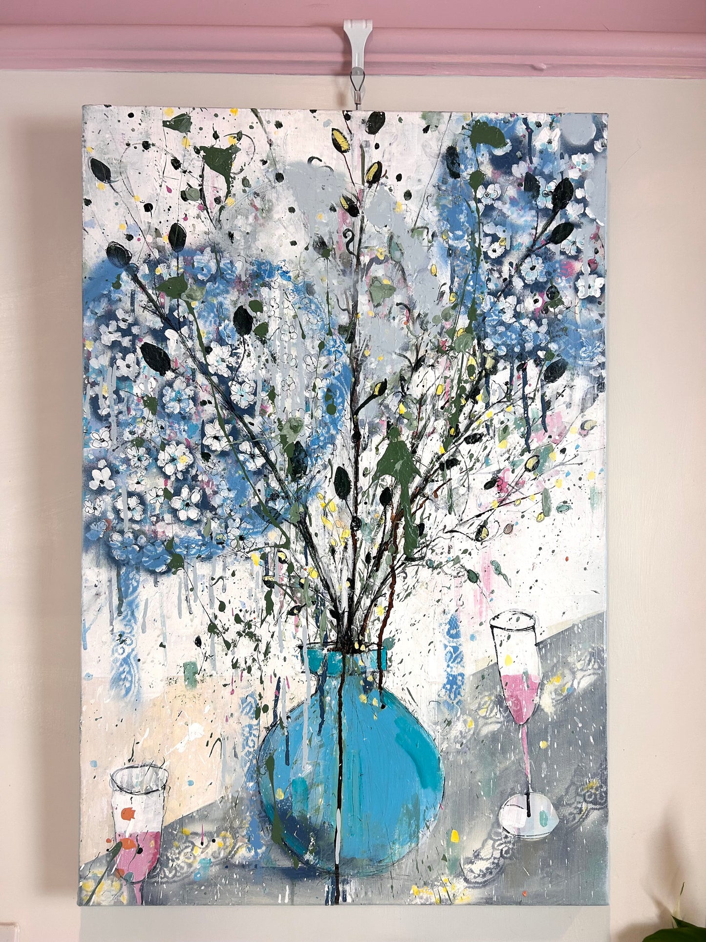 Hydrangeas in a blue vase and pink champagne