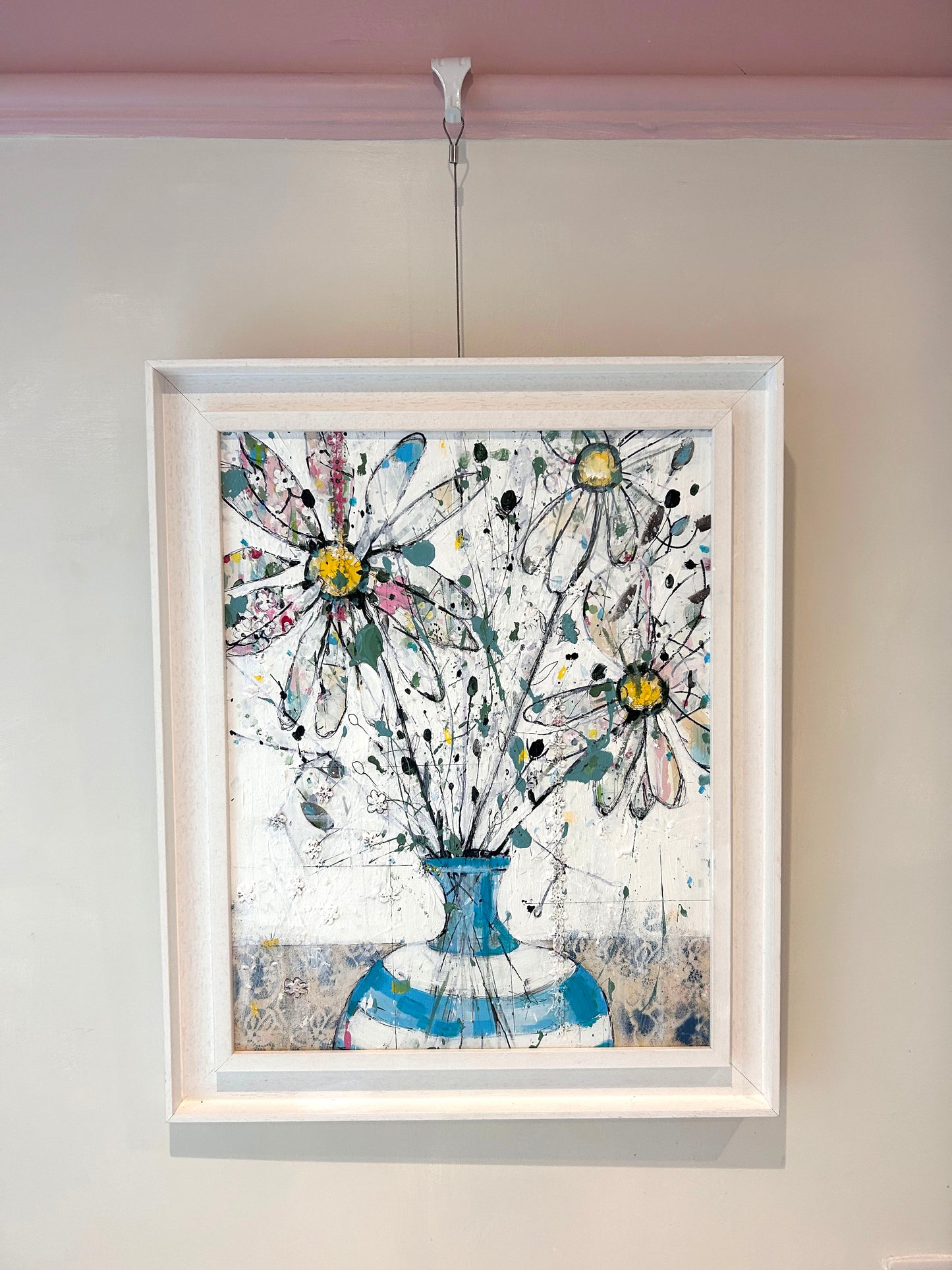 Daisies in blue stripped vase