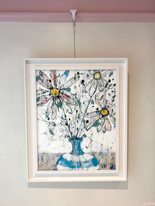 Daisies in blue stripped vase