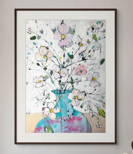 Delicate flowers in blue and pink vase