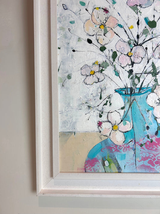 Delicate flowers in blue and pink vase