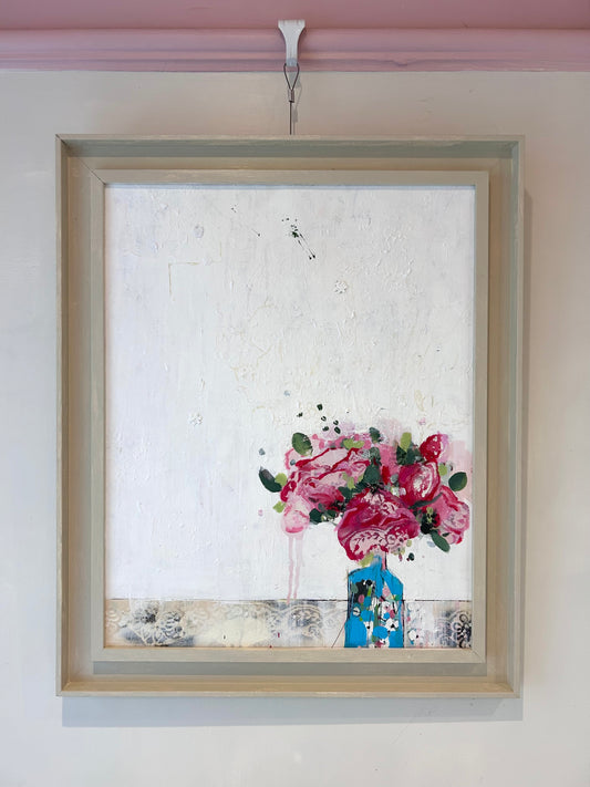 Peonies in a small blue vase
