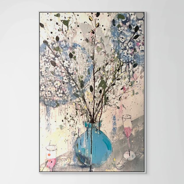 Hydrangeas in a blue vase and pink champagne