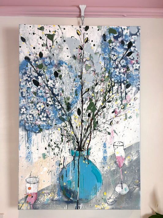 Hydrangeas in a blue vase and pink champagne